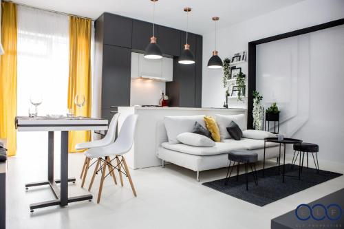 a living room with a white couch and a table at Cazare Voluntari in Voluntari
