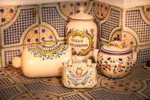 a group of vases sitting on a tiled floor at Agriturismo Bannata in Piazza Armerina
