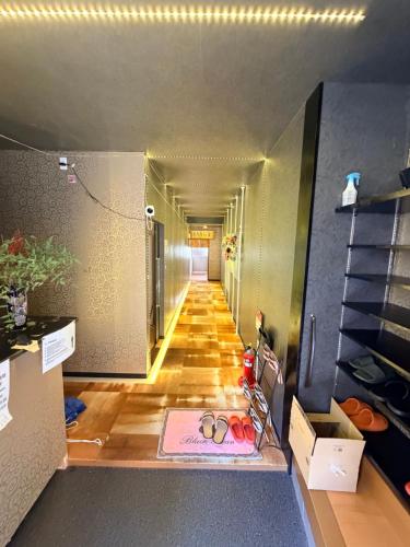 a hallway with two pairs of glasses on the floor at 仔鹿 kojika in Nara