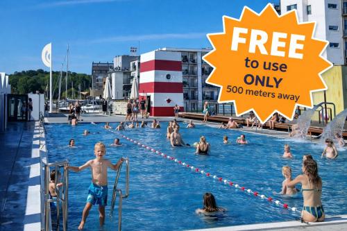 a group of people in a swimming pool at PAK Central apartment Odense C in Odense