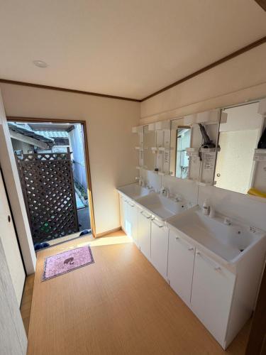 a bathroom with two sinks and a large mirror at 仔鹿 kojika in Nara