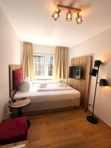 a bedroom with a large bed and a window at Spree - Waldhotel Cottbus in Cottbus