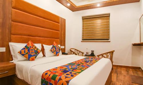 a bedroom with a large bed and a window at HOTEL AMBASSADOR SUKHNA LaKE in Chandīgarh