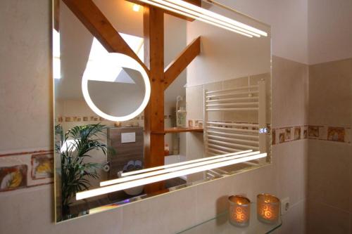 a mirror on a wall in a bathroom at Ferienwohnung an der südlichen Boddenküste in Bartelshagen