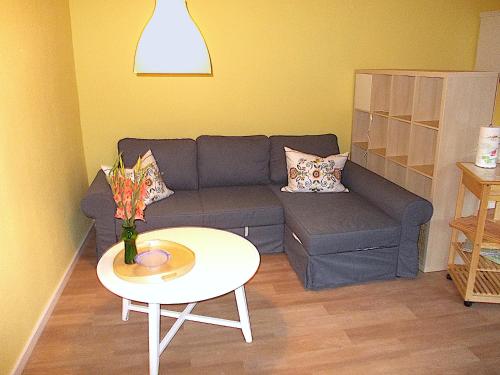 a living room with a couch and a table at FeWo Schwalbennest in Marlow