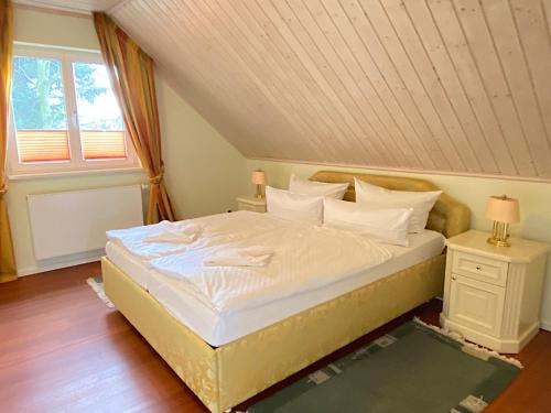 a bedroom with a large bed in a attic at Ferienvilla Recknitztal in Marlow