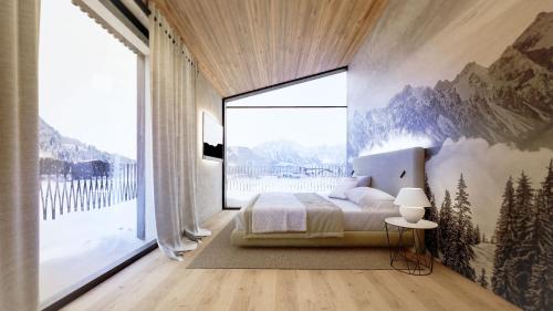 a bedroom with a bed and a large window at Wieshof Wilder Kaiser by ALPS RESORTS in Söll