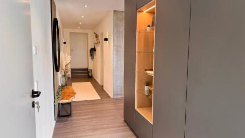 a hallway with a door open to a room with a hallway at Modern Luxury Apartment in Karsau