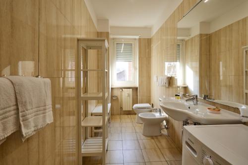 a bathroom with a sink and a toilet and a mirror at Hotel Galimberti in Turin