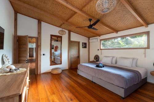 a bedroom with a large bed in a room at Baha Baha Villa Sailo Hts Mentawai Hollow Trees in Katiet