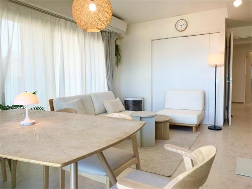 a living room with a table and chairs at O2 capsule house OTARU in Otaru