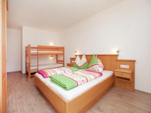 a bedroom with a bed and a bunk bed at Chalet in Mittersill near Ski Slopes in Mittersill