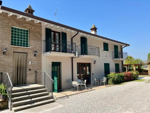 a house with a staircase and a balcony at Residence la Lucciola in Lonato