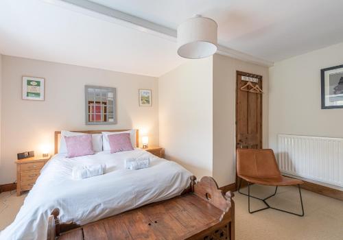 a bedroom with a large bed and a chair at Swale View in Feetham