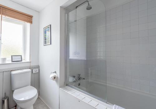 a bathroom with a toilet and a glass shower at Swale View in Feetham