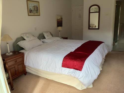 A bed or beds in a room at Riverdown B&B