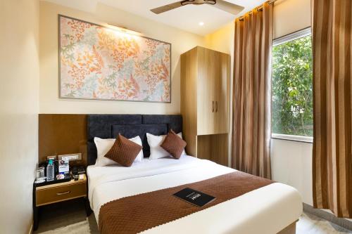 a hotel room with a bed and a window at asar Varanasi Junction by Orion Hotels in Varanasi