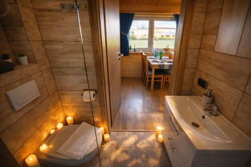 a bathroom with a sink and a tub with lights at Ośrodek Wypoczynkowy IGOR nad Jeziorem Żywieckim in Żywiec