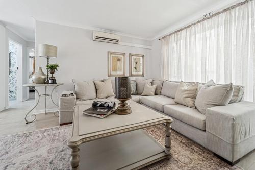 a living room with a couch and a table at The Willow Cottage in Oakdale