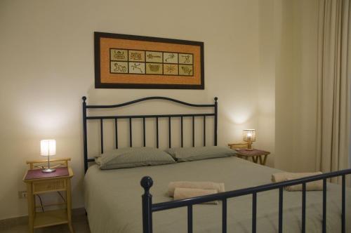 a bedroom with a bed and two night stands at Piccinni house in Bari