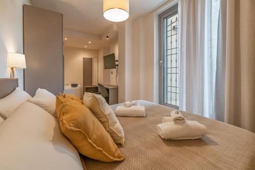a bedroom with a large bed with two towels on it at Villa Decimum in Ciampino