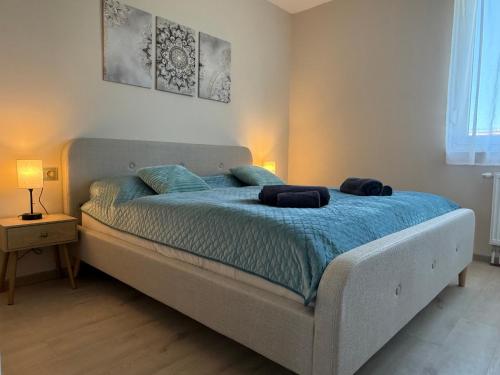 a bedroom with a bed with a blue comforter at K&T Apartman in Szentendre