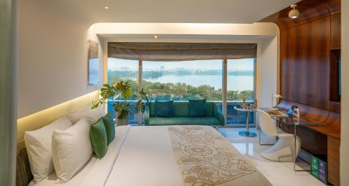 a living room with a couch and a large window at The Park Hyderabad, Banjara Hills near Hussain Sagar Lake in Hyderabad