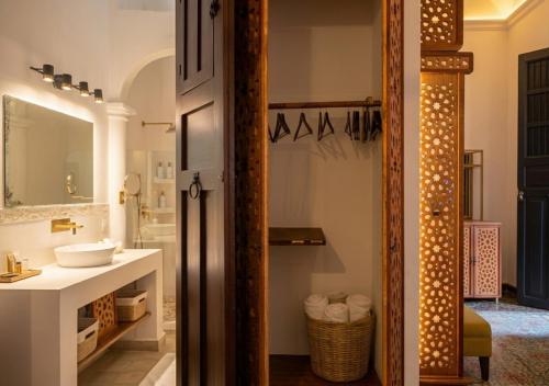 a bathroom with a sink and a mirror at Villa Merida Luxury Mansion - Adults Only Boutique Hotel in Mérida