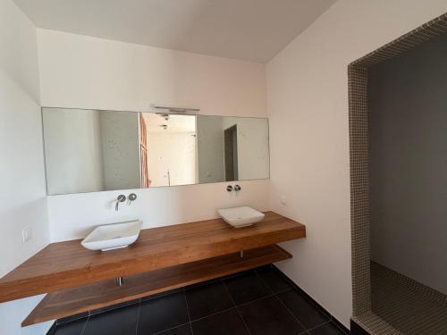 a bathroom with a sink and a mirror at Maison des Alizés in Oussouye