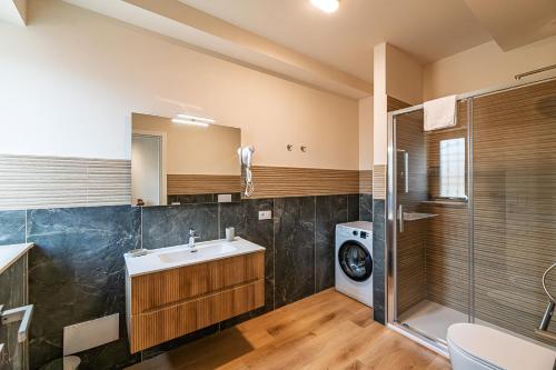 a bathroom with a sink and a washing machine at Villa Decimum in Ciampino
