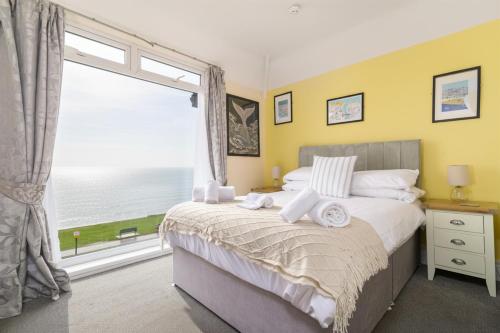 a bedroom with a bed and a large window at The Wheeldale in Whitby
