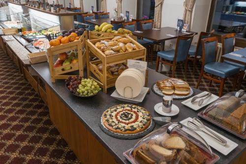 a buffet with bread and pastries on a table at OREA Spa Hotel Bohemia Mariánské Lázně in Mariánské Lázně