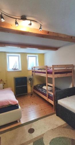 a bedroom with two bunk beds and a fireplace at Apartmán Víťazov in Trenčín