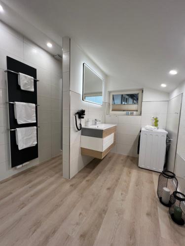a bathroom with a sink and a mirror at Marktplatzapartment 3 in Höxter