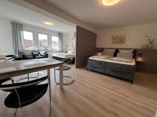 a bedroom with a bed and a desk in a room at Marktplatzapartment 3 in Höxter