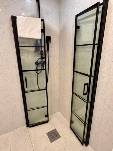 a shower with a glass door in a bathroom at Apartment Targowa L9 in Lublin