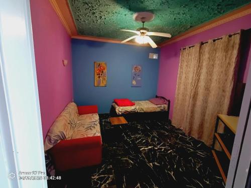 a room with two beds and a ceiling fan at House Lantana 1432 in Pentátion