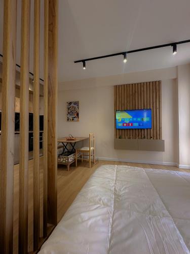 a living room with a television and a table at Coral Studio Apartment in Shëngjin