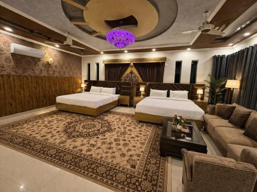 a hotel room with two beds and a couch at Comfort Family Villa Islamabad in Islamabad