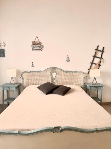 a bedroom with a large bed with two tables at Casa Vacanze Roberta in Follonica