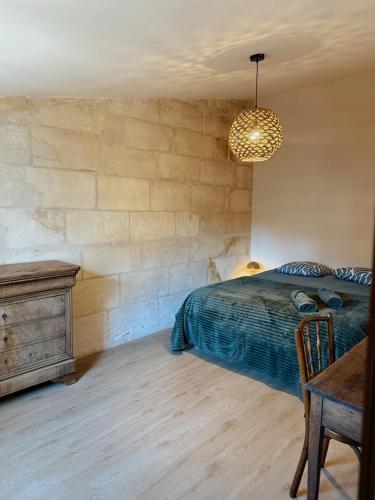 a bedroom with a bed and a desk and a table sidx sidx sidx at Le Voisin des Arènes in Arles
