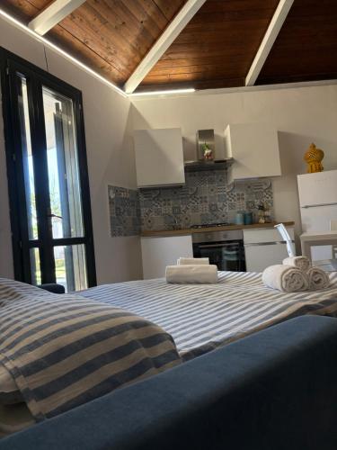 a bedroom with a bed with towels on it at Soleada Club in Campofelice di Roccella