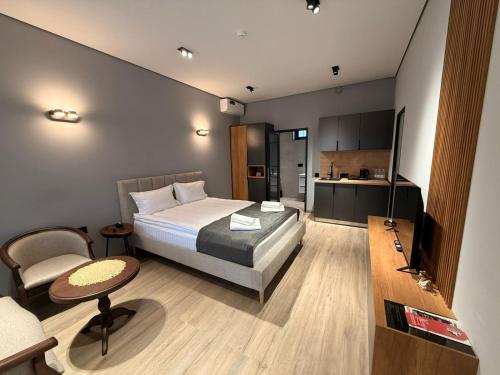 a hotel room with a bed and a kitchen at Mountain Symphony House Dilijan in Dilijan