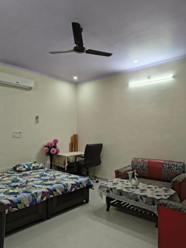 a bedroom with a bed and a couch and a ceiling at RS Homestay in Bareilly