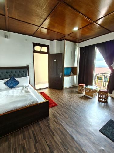 a large bedroom with a bed and a large window at Great Eastern Valley Residency in Gangtok
