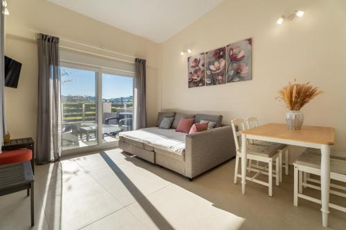 a living room with a couch and a table at ElGio Maisonette Nikiti in Nikiti
