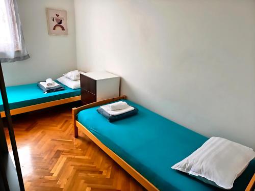 a room with two beds in a room at Gumla House in Stara Novalja