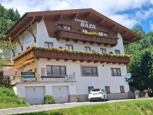 a large white building with a balcony at Pension Razil XO in Ladis