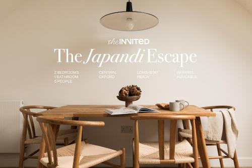 a table and chairs with a sign that reads the javascript escape at The Japandi Escape - 2BR Duplex in Central Oxford in Oxford