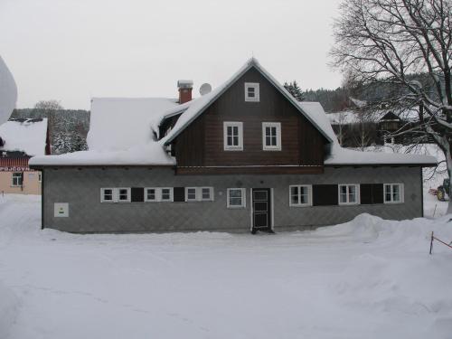 a house with snow on top of it at Pecka Penzion in Pec pod Sněžkou